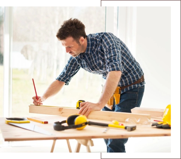 A man working on a table with tools in front of him.