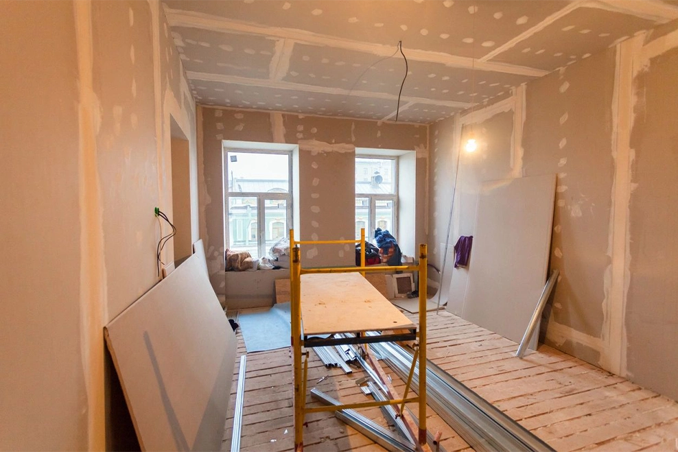 A room being remodeled with some scaffolding in the foreground.