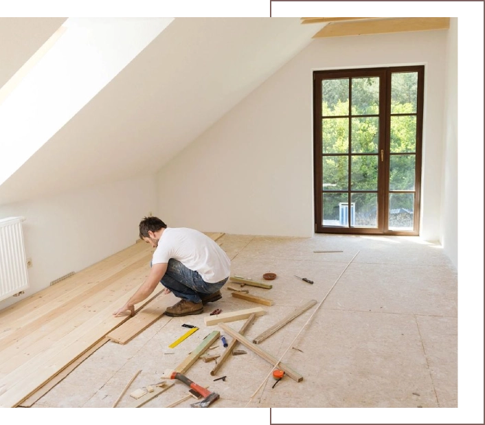 A man is working on the floor of his home.