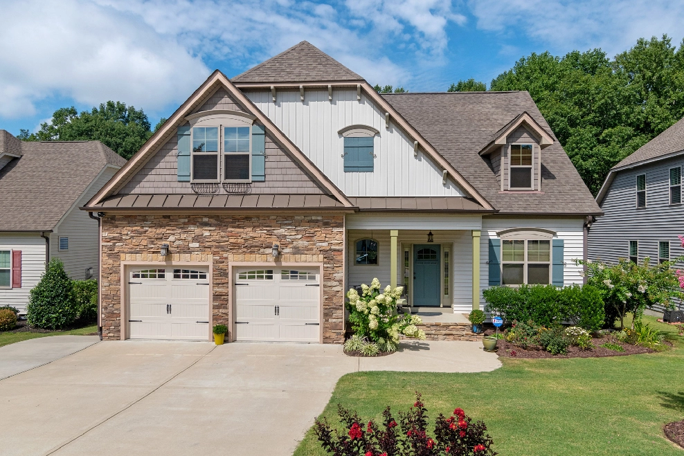 A house with two garage doors and a driveway.