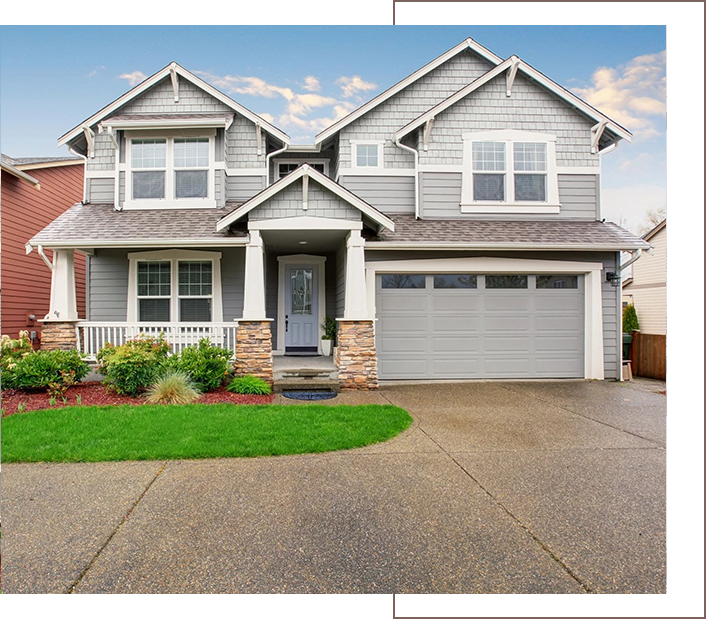 A house with a driveway and garage in front of it.